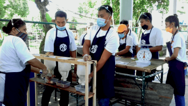 DTI sponsored poultry farming cooperative getting trained to dress chicken